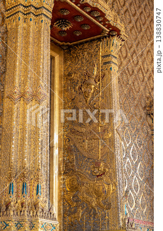 Tiny mirror pieces and gold surfaces show careful exterior work from the Rattanakosin era. The close framing reveals patient traditional craft. Tiny mirror pieces and gold surfaces show careful exterior work from the Rattanakosin era. The close framing reveals patient traditional craft. 138830747