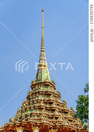 Tiny mirror pieces and gold surfaces show careful exterior work from the Rattanakosin era. The close framing reveals patient traditional craft. Tiny mirror pieces and gold surfaces show careful exterior work from the Rattanakosin era. The close framing reveals patient traditional craft. 138830749
