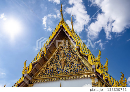 Tiny mirror pieces and gold surfaces show careful exterior work from the Rattanakosin era. The close framing reveals patient traditional craft. Tiny mirror pieces and gold surfaces show careful exterior work from the Rattanakosin era. The close framing reveals patient traditional craft. 138830751