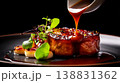 Gourmet dish with rich sauce being drizzled over a perfectly cooked piece of meat 138831362