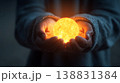 Holding a glowing sun orb in cupped hands, symbolizing hope and new beginnings 138831384