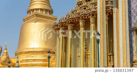 Patterned walls, frames, and roof edges create a rich study of Thai temple design. Repeated motifs and colors fill each close architectural view. 138831397