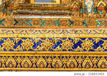 Patterned walls, frames, and roof edges create a rich study of Thai temple design. Repeated motifs and colors fill each close architectural view. Patterned walls, frames, and roof edges create a rich study of Thai temple design. Repeated motifs and colors fill each close architectural view. 138831403