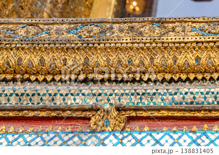 Patterned walls, frames, and roof edges create a rich study of Thai temple design. Repeated motifs and colors fill each close architectural view. Patterned walls, frames, and roof edges create a rich study of Thai temple design. Repeated motifs and colors fill each close architectural view. 138831405