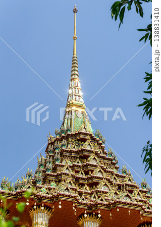Patterned walls, frames, and roof edges create a rich study of Thai temple design. Repeated motifs and colors fill each close architectural view. 138831410