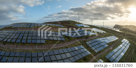 Solar energy panels photovoltaic cell and wind power plants on the seashore landscape for production of renewable green energy 138831760