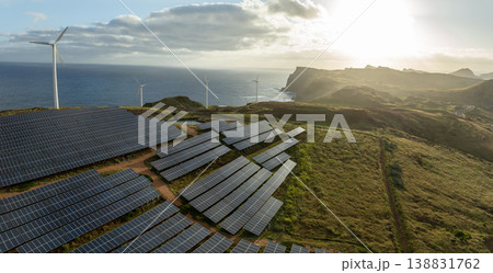 Solar energy panels photovoltaic cell and wind power plants on the seashore landscape for production of renewable green energy 138831762