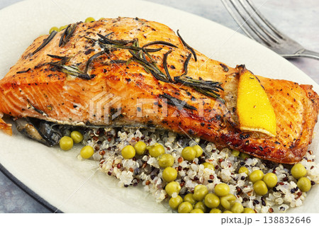 Oven roasted salmon with lemon, quinoa and green peas Oven roasted salmon with lemon, quinoa and green peas 138832646