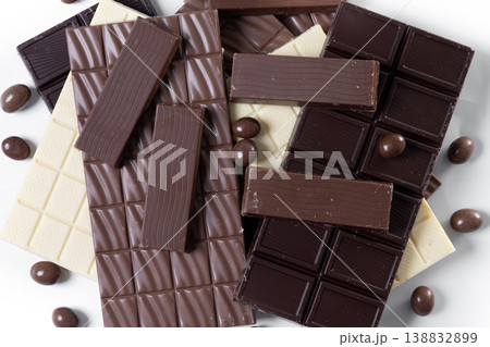 Assortment of white, milk and dark chocolate pieces isolated on white background Assortment of white, milk and dark chocolate pieces isolated on white background 138832899