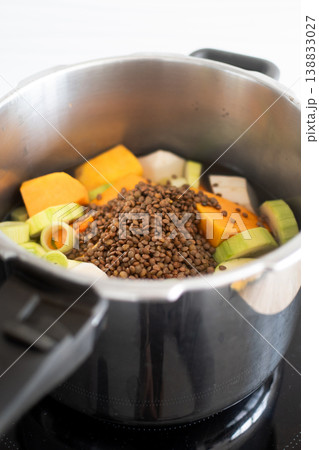 Healthy homemade vegetable soup preparation with lentils and fresh ingredients in pot Healthy homemade vegetable soup preparation with lentils and fresh ingredients in pot 138833027