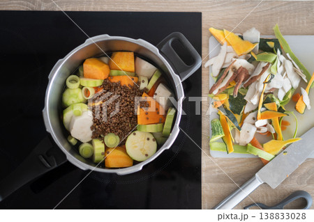 Healthy homemade vegetable soup preparation with lentils and fresh ingredients in pot Healthy homemade vegetable soup preparation with lentils and fresh ingredients in pot 138833028