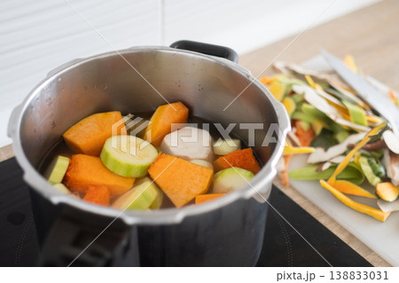 Healthy homemade vegetable soup preparation with lentils and fresh ingredients in pot Healthy homemade vegetable soup preparation with lentils and fresh ingredients in pot 138833031