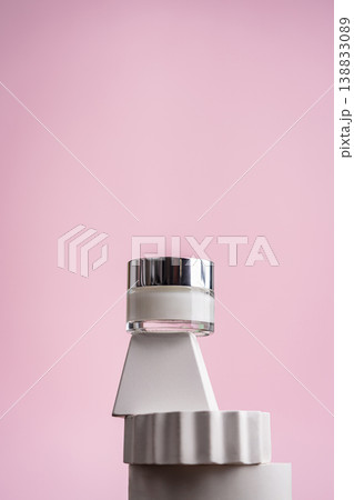 Anti-age eye cream jar on geometric white stands with pink background Anti-age eye cream jar on geometric white stands with pink background 138833089