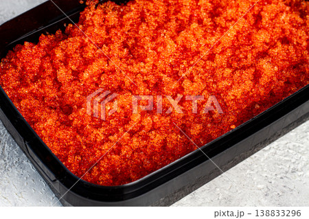 container with orange caviar, flying fish, Tobiko, on the table, caviar for rolls and sushi, close-up, container with orange caviar, flying fish, Tobiko, on the table, caviar for rolls and sushi, close-up, 138833296