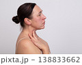 Middle-aged woman in profile with age-related changes requiring plastic surgery. 138833662
