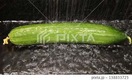 Fresh cucumber under running water in kitchen sink before preparation Fresh cucumber under running water in kitchen sink before preparation 138833725
