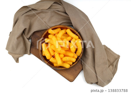 Cheese flavored corn puffs in wooden bowl isolated on white background, crunchy savory snack food 138833788