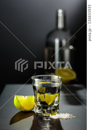 Mexican Tequila shot with lime and salt on black table. 138833935