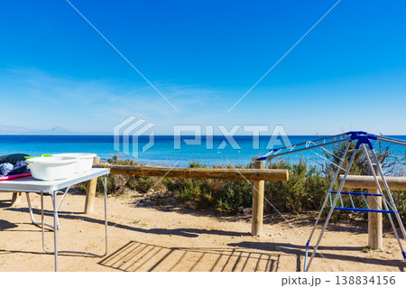 Camping on beach, empty clotheshorse Camping on beach, empty clotheshorse 138834156