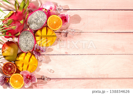 Fresh dragon fruit, pitahaya, mango, blood orange, lemons, kiwi and oranges close-up. Summer exotic tropical fruits, banner for a cafe or store, postcard for advertising an Asian market 138834626