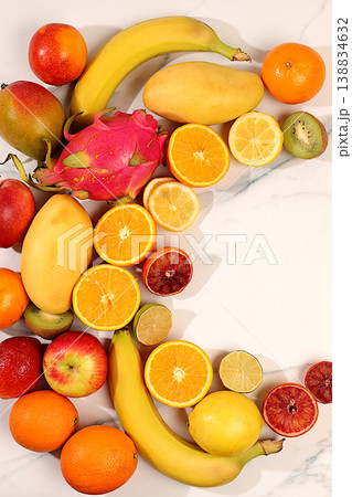 Healthy vegan products for healthy lifestyle. Apples, oranges, lemons, tangerines, bananas and natural juice on concrete background, detox diet and weight loss concept, store advertisement. 138834632