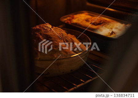 Homemade pie baking in oven with golden crust and melted cheese 138834711