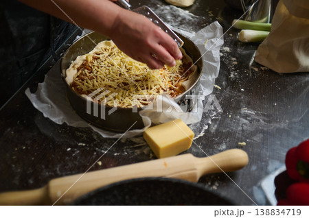 Final cheese topping added to homemade lasagna before baking 138834719