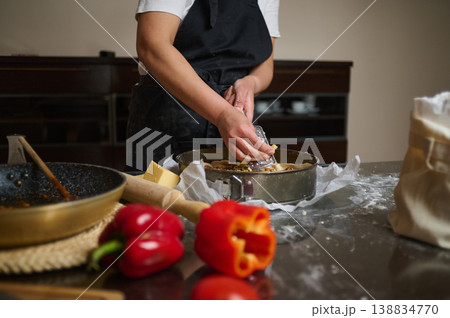 Preparing layered lasagna with sauce and fresh dough in kitchen 138834770
