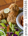 Crispy Chicken Skewers with Fresh Salad Close Up 138835686