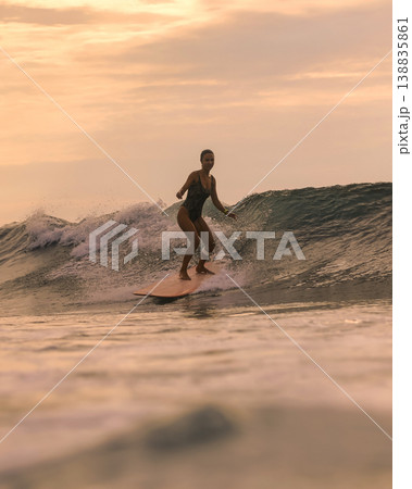 Skilled Surf Coach Performing Sharp Maneuvers In Golden Evening Light 138835861