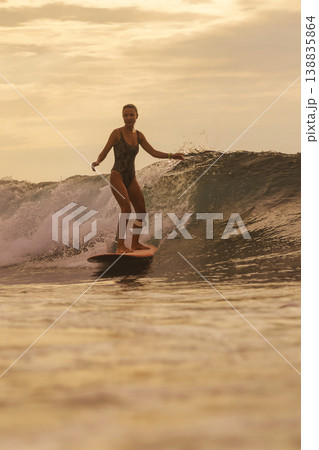 Skilled Surf Coach Performing Sharp Maneuvers In Golden Evening Light Skilled Surf Coach Performing Sharp Maneuvers In Golden Evening Light 138835864