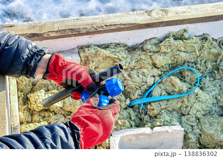 Plastic compression tee fitting in hands of well contractor. Plastic compression tee fitting in hands of well contractor. 138836302