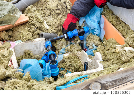 Use of plastic compression fittings for HDPE pipes during installation of distribution piping in artesian well pit. 138836303