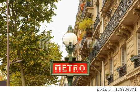 Paris Metro sign with classic Haussmann building, capturing city travel, architecture, and urban landmark Paris Metro sign with classic Haussmann building, capturing city travel, architecture, and urban landmark 138836371