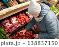 Senior woman shopping in modern supermarket during winter 138837150