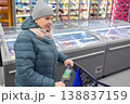 Senior woman shopping in modern supermarket during winter 138837159