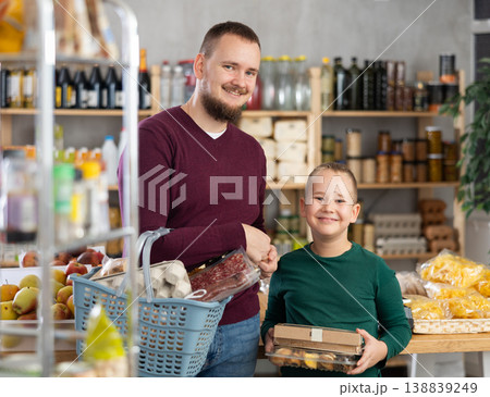 Dad and son are choosing products in supermarket 138839249