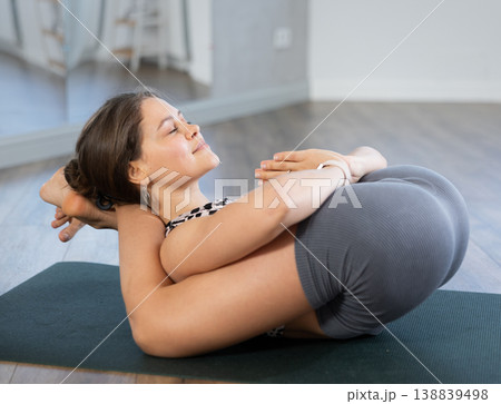 Young girl performing Yoganidrasana with hands in namaste 138839498