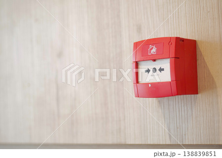 Fire alarm box is mounted on a wooden wall 138839851