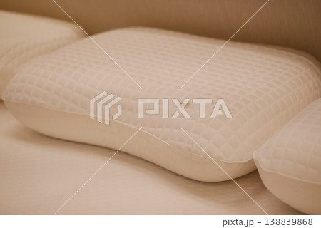 orthopedic pillows arranged on a bed during the day orthopedic pillows arranged on a bed during the day 138839868