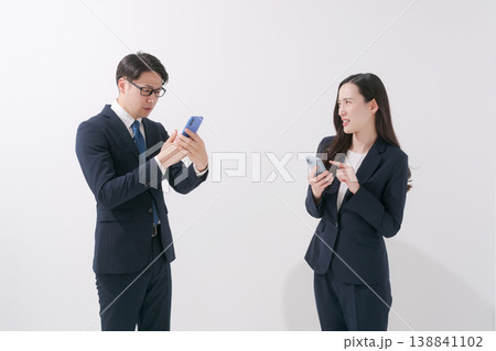 スマホを見る2人のビジネスパーソン 138841102