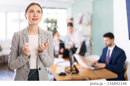 Upset woman stands in the middle of the office 138842146