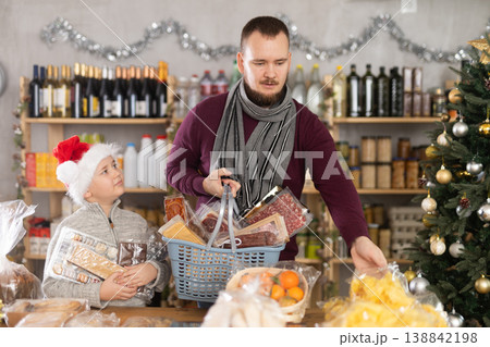 Man and boy choosing chips in grocery store 138842198