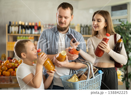 Couple of man and woman with boy scanning qr code of juices 138842225