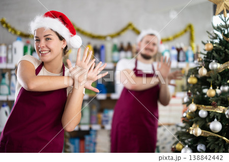 Woman and man sellers dance in household chemicals store Woman and man sellers dance in household chemicals store 138842442