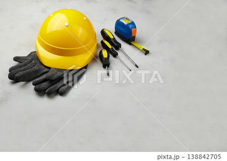 Happy labor day concept. Construction tools, yellow helmet on dark wooden background Happy labor day concept. Construction tools, yellow helmet on dark wooden background 138842705