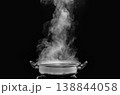 steam over cooking pot in kitchen on dark background. 138844058