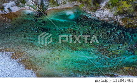 Aerial view of Soca river with its distinctive emerald green colour, nestled between the Julian Alps in western Slovenia. Aerial view of Soca river with its distinctive emerald green colour, nestled between the Julian Alps in western Slovenia. 138845469