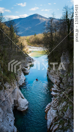 Kayaker paddling in Soca River turquoise canyon in Julian Alps Slovenia. Vertical shot Kayaker paddling in Soca River turquoise canyon in Julian Alps Slovenia. Vertical shot 138845485