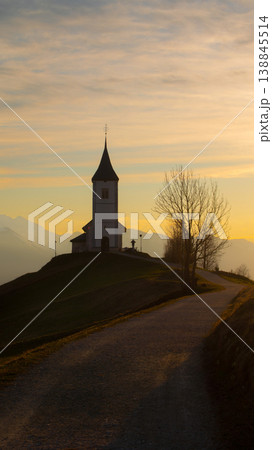 Vertical sunrise view of Jamnik Church in Slovenia with pastel sky and copy space Vertical sunrise view of Jamnik Church in Slovenia with pastel sky and copy space 138845514